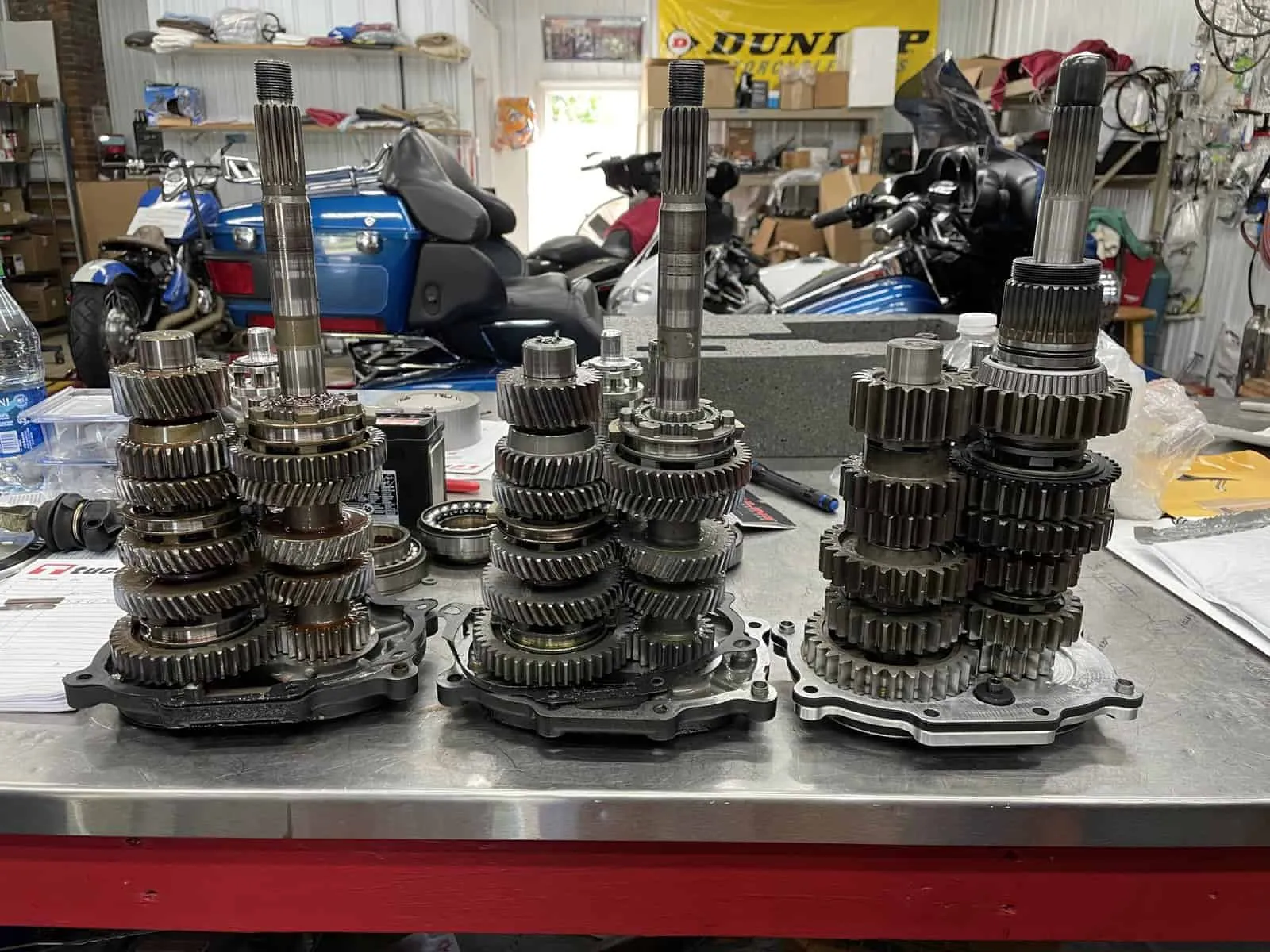 Harley transmission gear sets laid out on the bench during a rebuild
