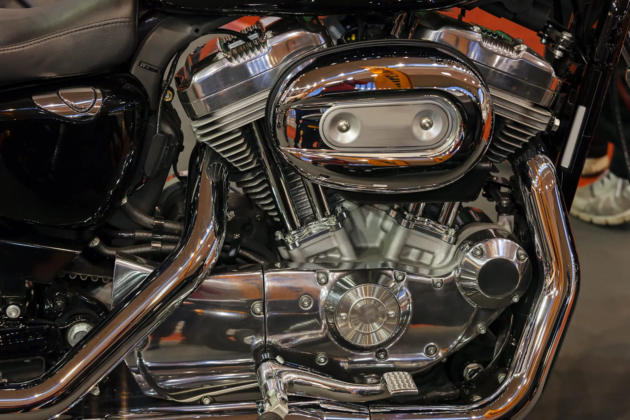 Chrome V-twin engine and exhaust on a black Harley